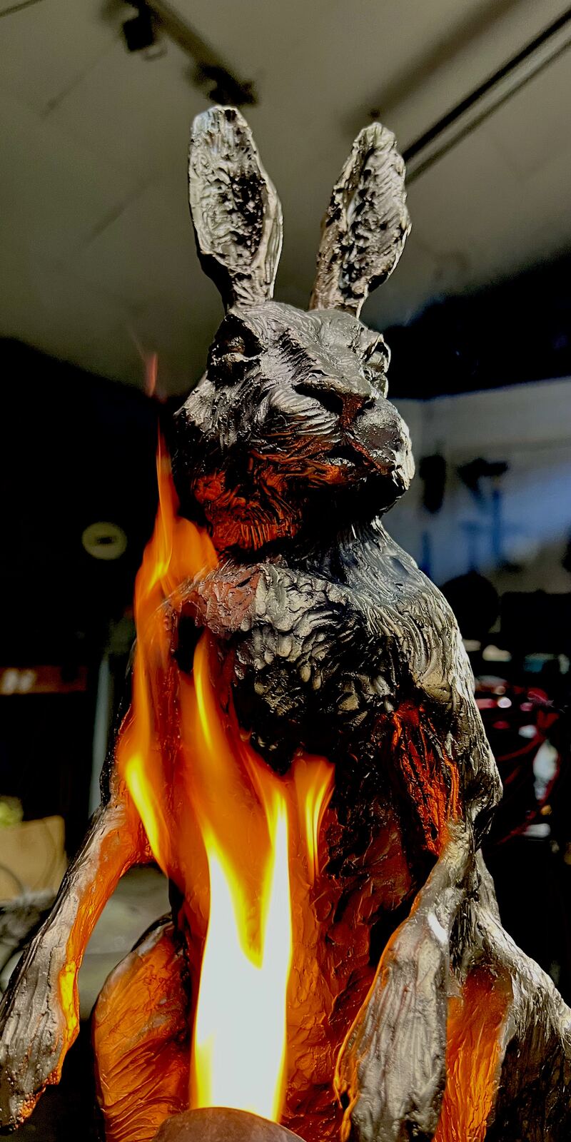 Bronze hare being heated with a torch during patination